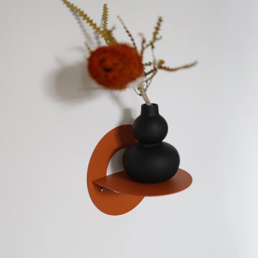 Small orange textured metal wall shelf